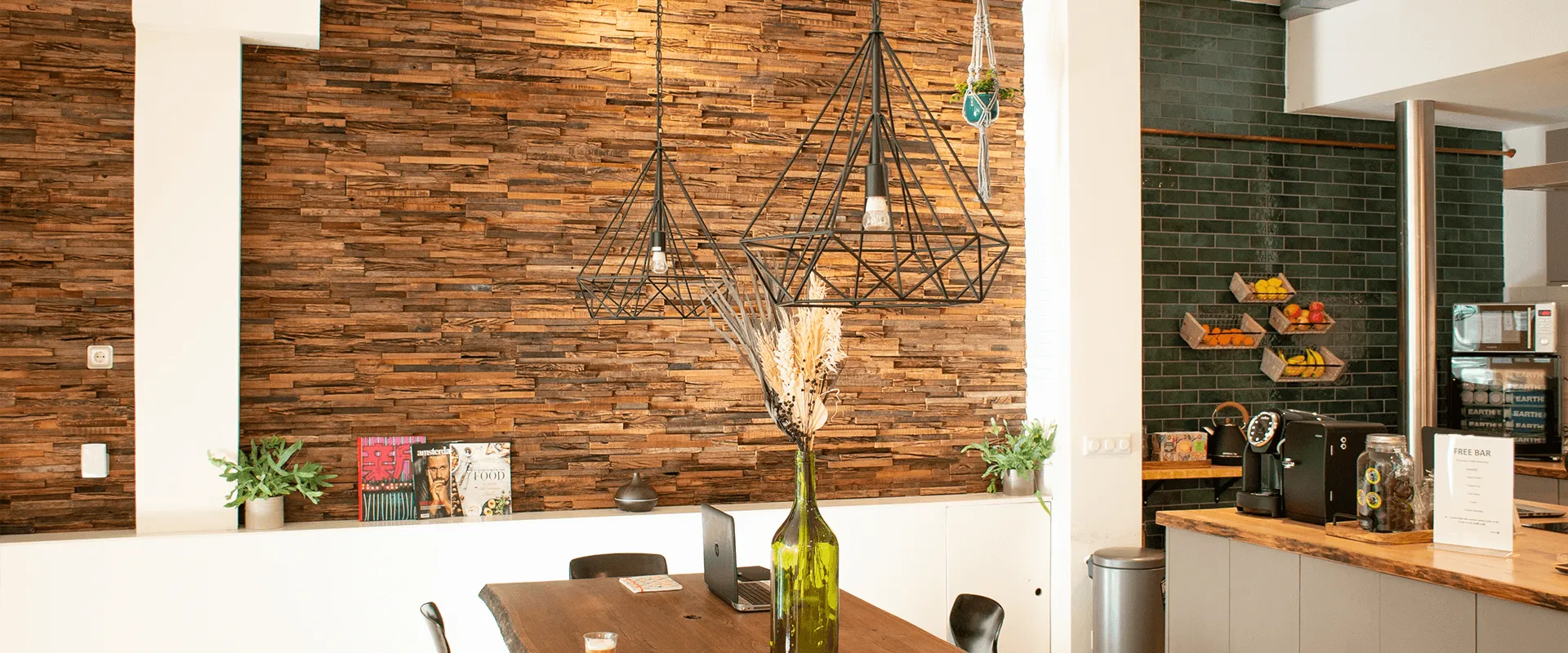The BeyondFit lounge with wooden wall, dining table and pendant lights