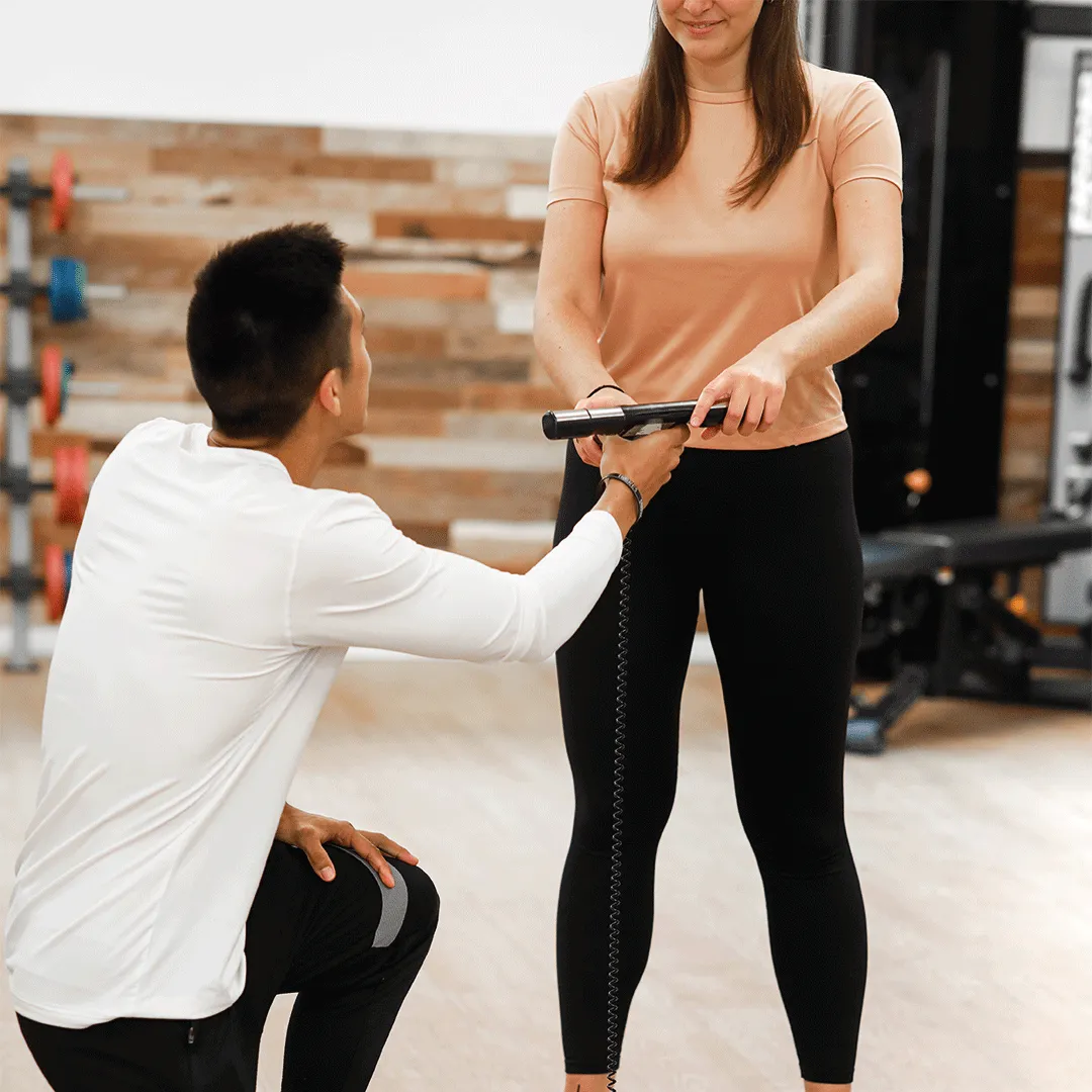 Personal trainer and client performing workout